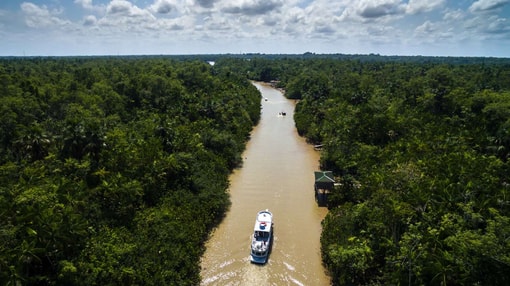 An Ariel view of a Ferry passing through the Amazon Rainforest in Brazil.